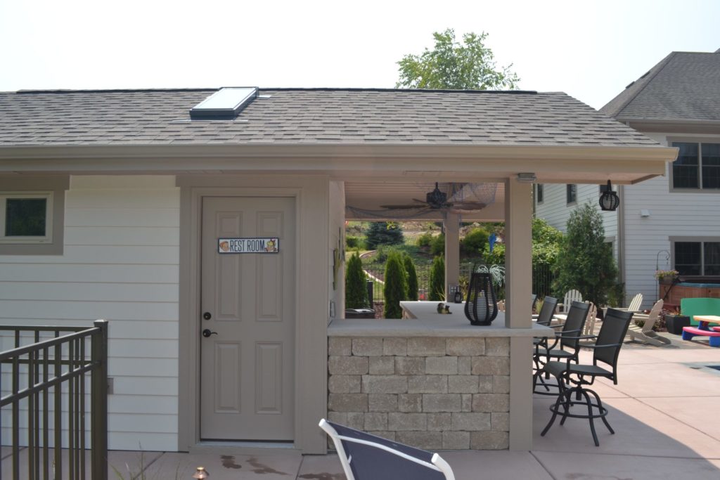 Pool house in Waukesha Wisconsin featuring side entry door for pool equipment storage.